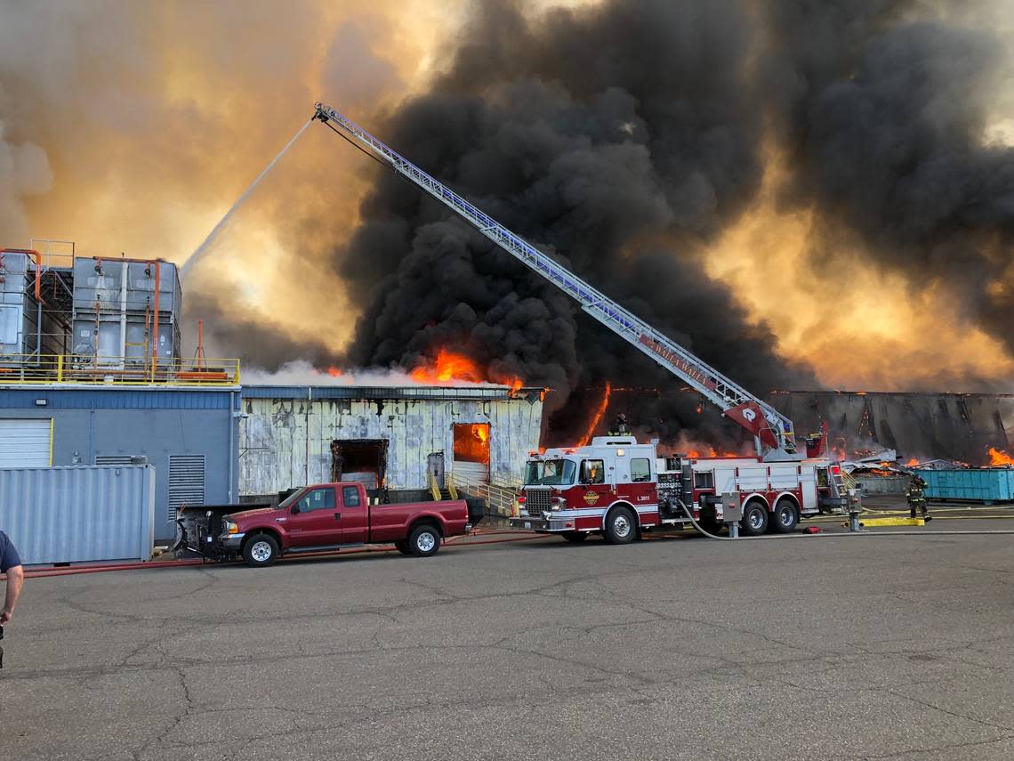 A Kennewick fire ladder truck works on dousing the fire at the Lineage Logistics warehouse in Finley.