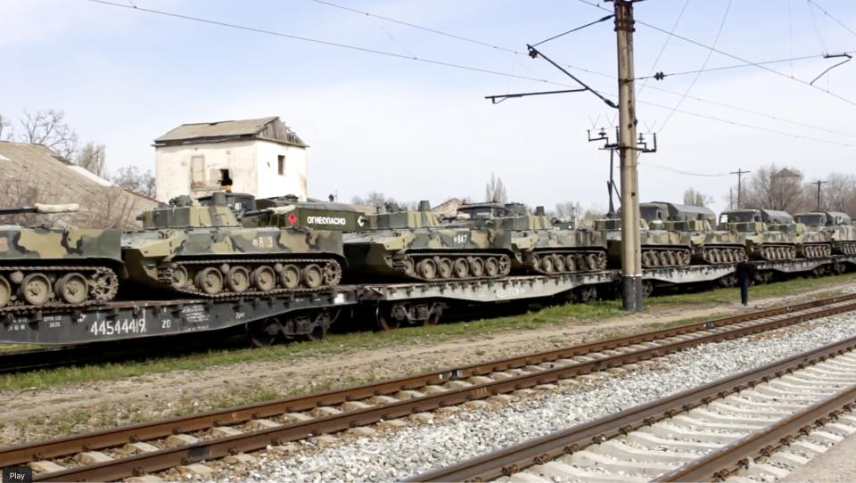 This handout photo taken from a video released on Friday, April 23, 2021, by Russian Defense Ministry Press Service shows, Russian military vehicles stand on railway platforms to be carried back to their base after drills in Crimea. Russian Defense Minister Sergei Shoigu on Thursday ordered troops back to their permanent bases after a massive military buildup that caused Ukrainian and Western concerns. (Russian Defense Ministry Press Service via AP)