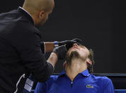 Russia's Daniil Medvedev receives treatment from trainer for a nosebleed during his second round singles match against Spain's Pedro Martinez at the Australian Open tennis championship in Melbourne, Australia, Thursday, Jan. 23, 2020. (AP Photo/Andy Brownbill)