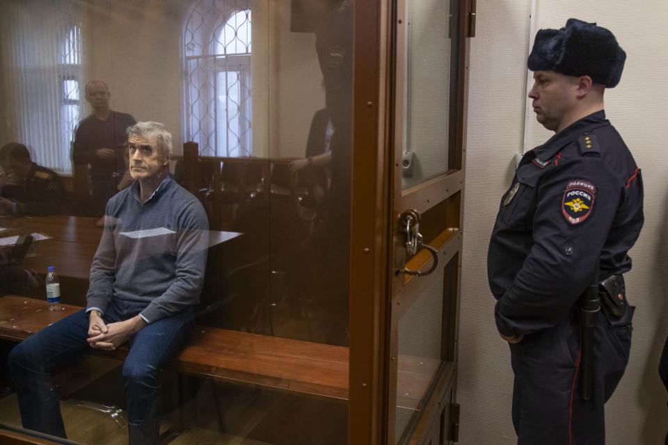 Founder of the Baring Vostok investment fund Michael Calvey looks through a cage's class in the court room in Moscow, Russia, Saturday, Feb. 16, 2019. A Moscow court has ordered Baring Vostok's founder Michael Calvey to be kept in custody until April 13, 2019. (AP Photo/Alexander Zemlianichenko)