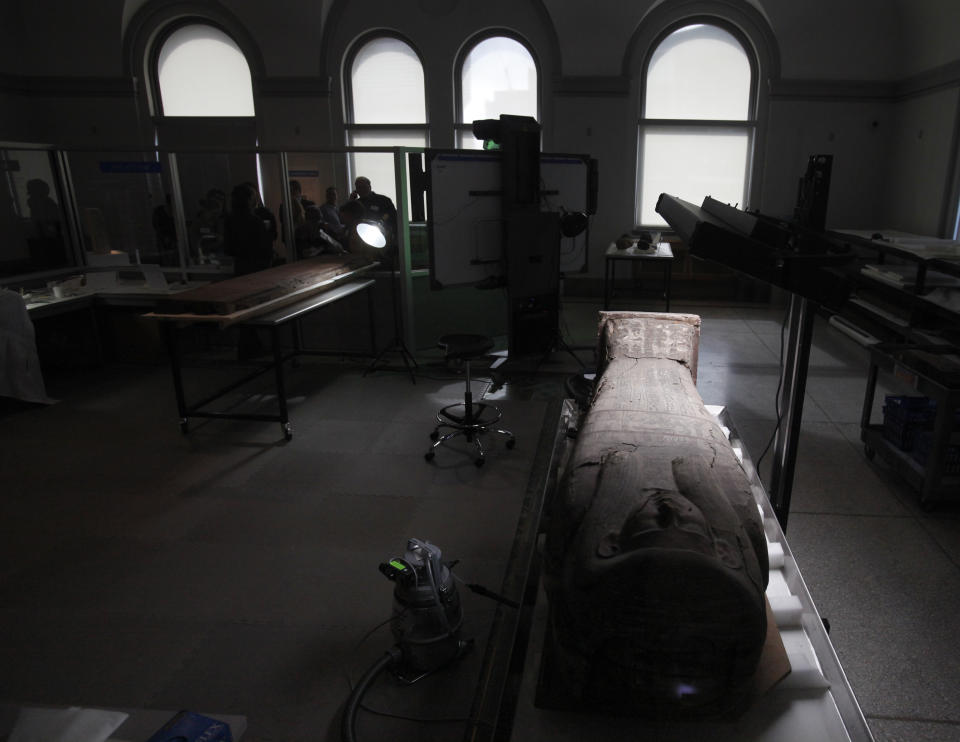 In this photo taken Friday, Oct. 19, 2012, a wooden sarcophagus is shown at the Penn Museum in Philadelphia. The newly installed Artifact Lab at the Penn Museum allows visitors to peek behind the scenes as staff members preserve relics from ancient Egypt. Human and animal mummies, as well as an intricately inscribed coffin, are among the items currently undergoing treatment and repair. (AP Photo/Jacqueline Larma)