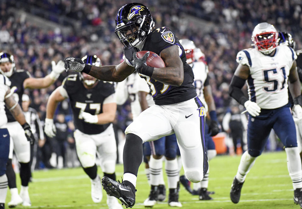 Baltimore Ravens running back Gus Edwards (35) runs for a 12-yard touchdown in the second quarter against the New England Patriots. (Getty Images)