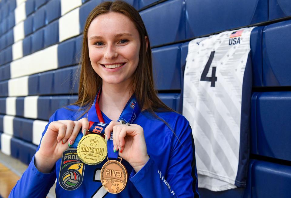 Bergen Reilly poses for a portrait with three of her volleyball medals on Thursday, December 8, 2022, at O’Gorman High School in Sioux Falls.