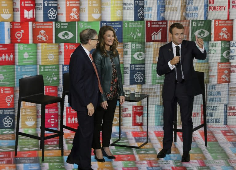 Melinda French Gates, pictured in 2018 with Bill Gates (left) and French President Emmanuel Macron, has pledged to use her fortune to help women and families (Ludovic MARIN)