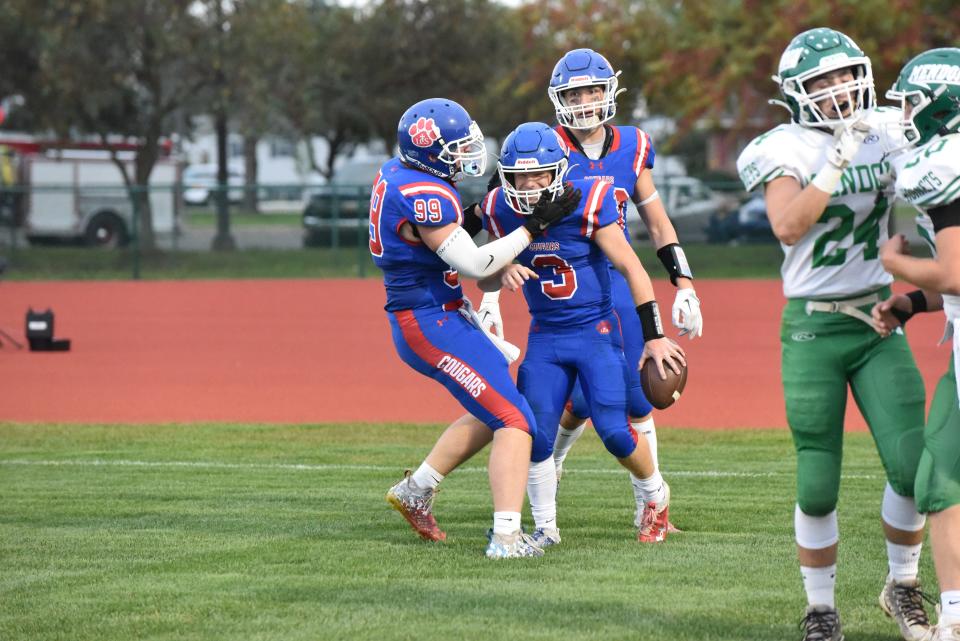 Lenawee Christian's Sam Lutz (3) celebrates a touchdown with Gage Hammang (99) and Easton Boggs during Friday's game against Mendon.