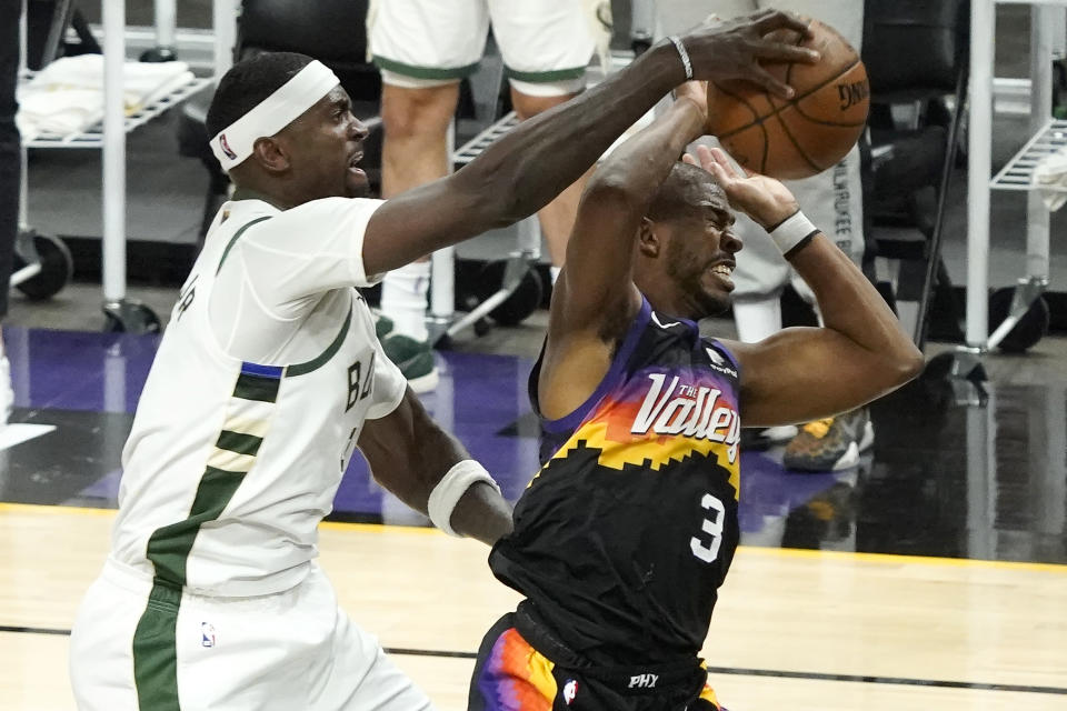 Milwaukee Bucks center Bobby Portis, left, defends Phoenix Suns guard Chris Paul (3) during the second half of Game 5 of basketball's NBA Finals, Saturday, July 17, 2021, in Phoenix. (AP Photo/Matt York)