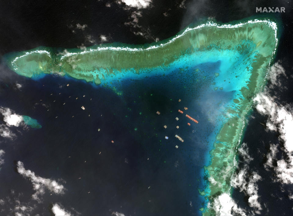 This satellite image provided by Maxar Technologies shows Chinese vessels in the Whitsun Reef located in the disputed South China Sea. Tuesday, March 23, 2021. The United States said Tuesday it’s backing the Philippines in a new standoff with Beijing in the disputed South China Sea, where Manila has asked a Chinese fishing flotilla to leave a reef. China ignored the call, insisting it owns the offshore territory. (©2021 Maxar Technologies via AP)