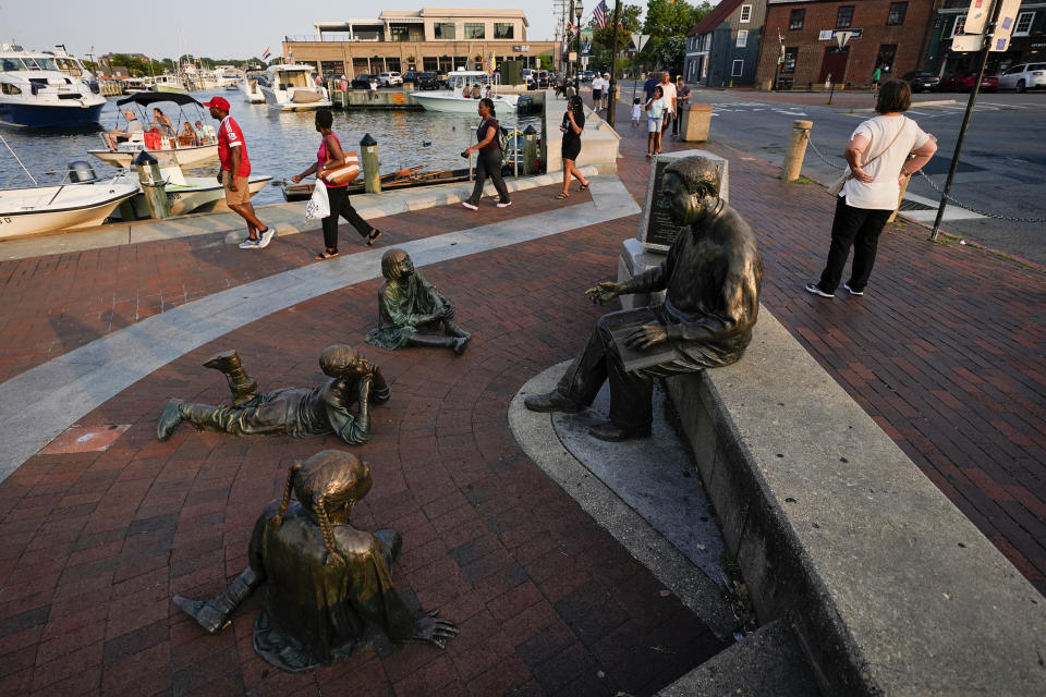 People walk near the waterfront in Annapolis, Md., on the evening after a jury gave a verdict in the trial of the Annapolis Capital Gazette newspaper shooting, Thursday, July 15, 2021, in Annapolis, Md. Jarrod W. Ramos, the gunman, was found criminally responsible by the jury, rejecting defense attorneys' mental illness arguments, on Thursday. (AP Photo/Julio Cortez)