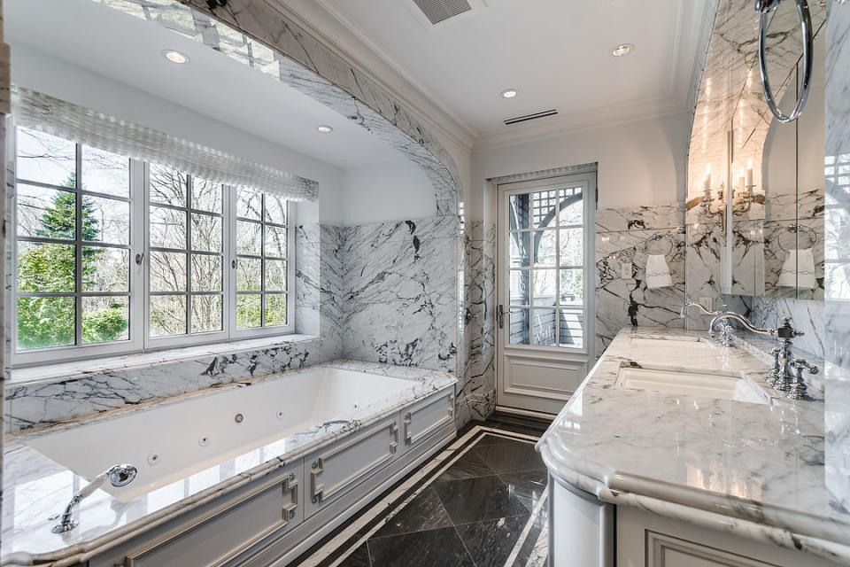 <p>The home has five bedrooms, five bathrooms and two half bathrooms. The master ensuite is resplendent in marble with a large soaker tub and double sinks, plus access to a private deck. (Listing via <span>Sotheby’s</span>) </p>