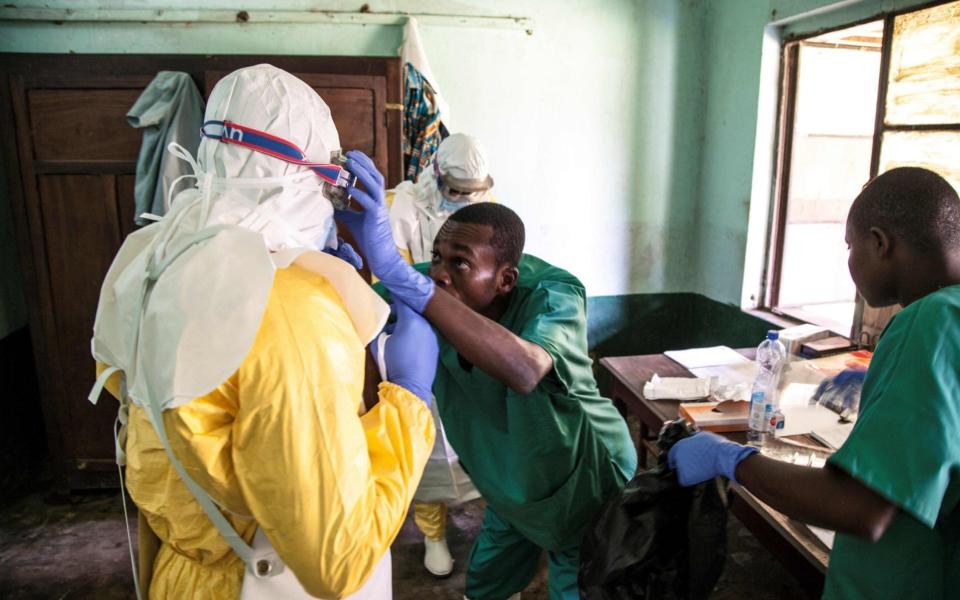 Health workers wear protective equipment as they prepare to attend to suspected Ebola patients at Bikoro Hospital, Equateur province, DRC - ARK NAFTALIN/AFP/Getty Images