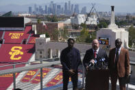 Former USC football player Reggie Bush, left, with his attorneys, Levi McCathern, middle, and Ben Crump, speak at a news conference announcing a defamation lawsuit against the NCAA at the Los Angeles Memorial Coliseum, Wednesday, Aug. 23, 2023, in Los Angeles. (AP Photo/Damian Dovarganes)