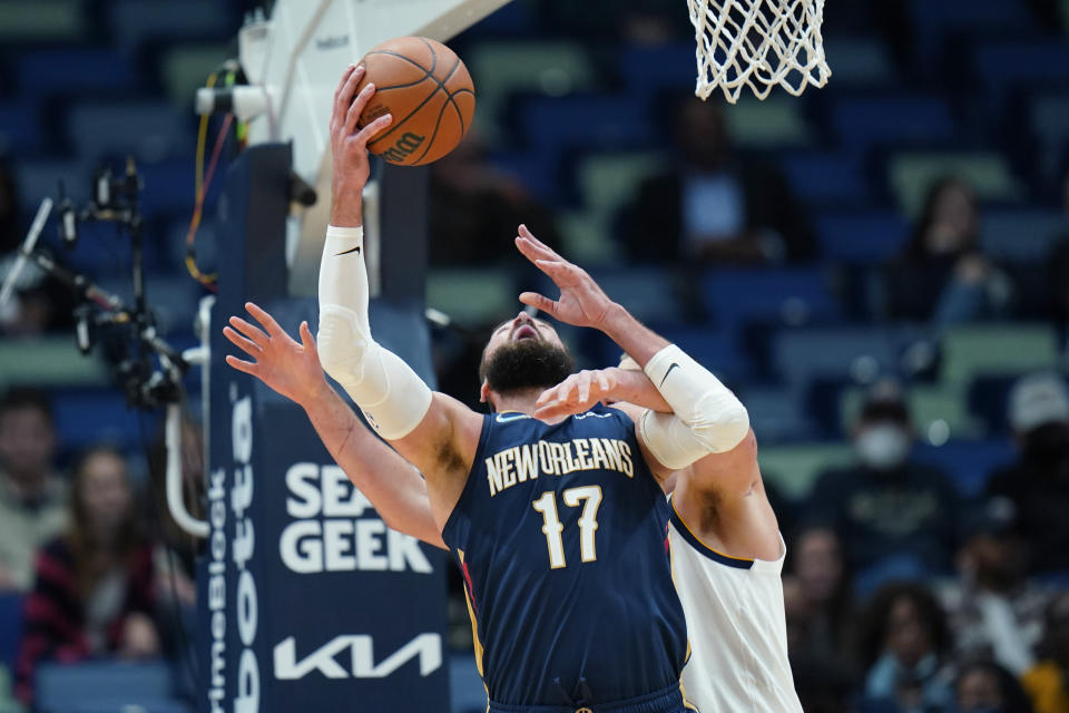 New Orleans Pelicans center Jonas Valanciunas (17) goes to the basket against Denver Nuggets center Nikola Jokic in the first half of an NBA basketball game in New Orleans, Wednesday, Dec. 8, 2021. (AP Photo/Gerald Herbert)