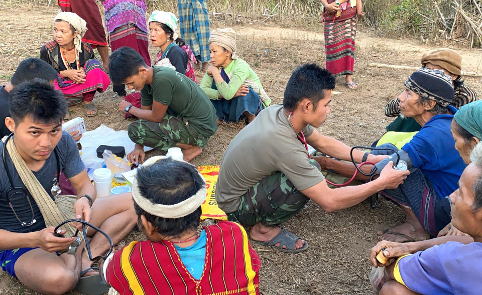 In this photo released by the Free Burma Rangers, members of the humanitarian group Free Burma Rangers carry out medical checkups on villagers in the northern Karen State, Myanmar Feb. 25, 2021. The group has been bringing aid to some of the 8,000 ethnic people forced to flee their homes by an ongoing local offensive by the Myanmar army aimed at increasing the military’s presence in the remote region. (Free Burma Rangers via AP)