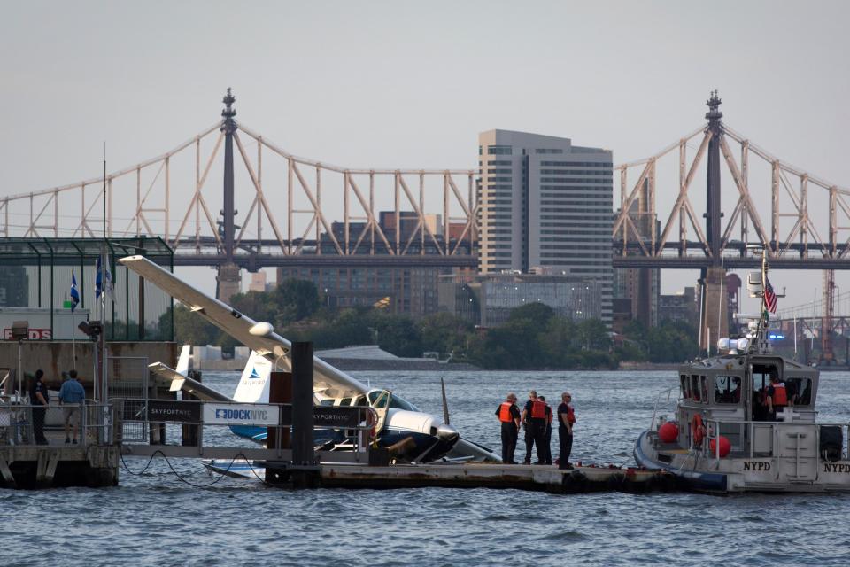 Emergency services attend to a seaplane that made a hard landing during a failed takeoff - Credit: Kevin Hagen/AP