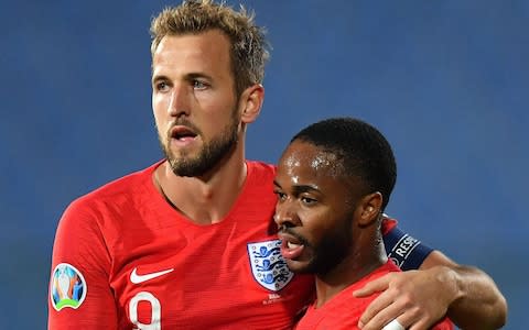 Raheem Sterling celebrates after scoring with his Harry Kane - Credit: REX