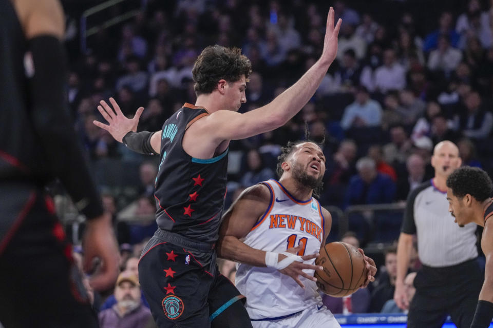 New York Knicks guard Jalen Brunson (11) drives against Washington Wizards forward Deni Avdija, left, in the first half of an NBA basketball game Thursday, Jan. 18, 2024, at Madison Square Garden in New York. (AP Photo/Mary Altaffer)