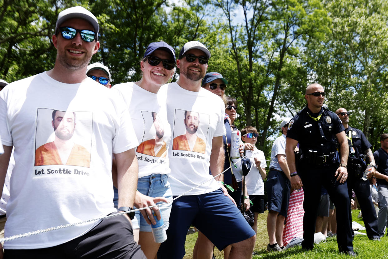 LOUISVILLE, KY - MAY 18: Fans wears Scottie Scheffler mugshot t-shirts in front of Louisville Metro Police officers following Scheffler's group during the third round of the PGA Championship, May 18, 2024, at Valhalla Golf Club in Louisville, Kentucky.(Photo by Matthew Maxey/Icon Sportswire via Getty Images)