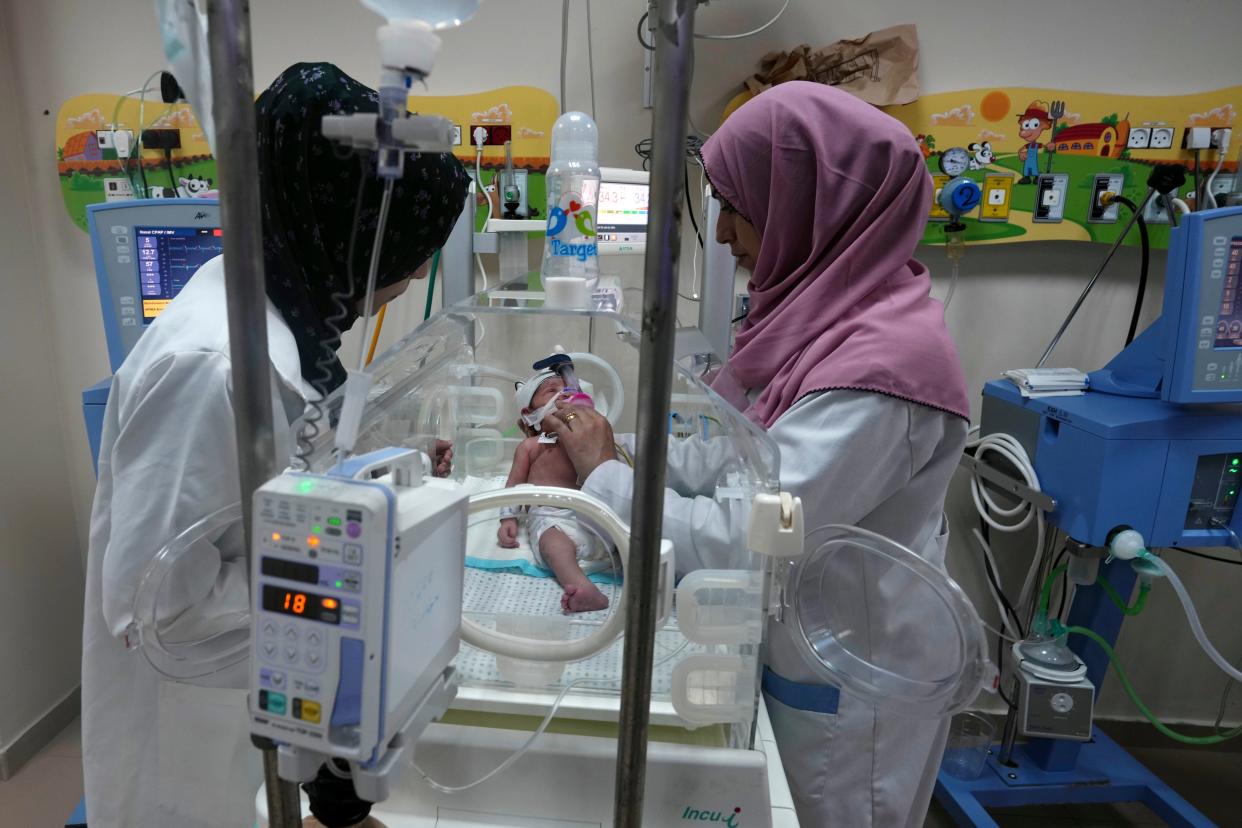 Doctors treat a prematurely born baby in Gaza (AP)