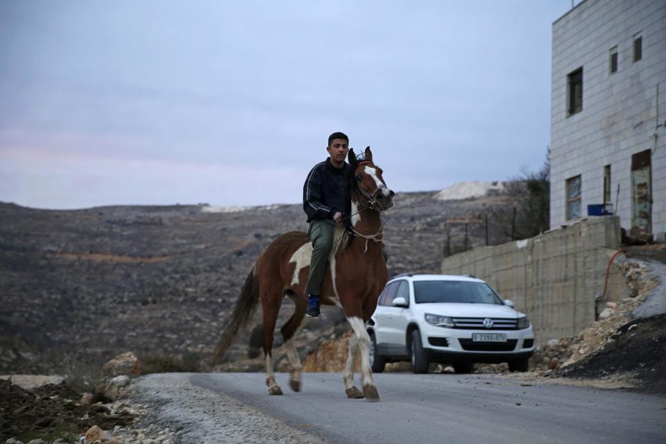 In this Thursday, Jan. 5, 2017 photo, Palestinian Hamza Hamad,16, rides his horse at his home, in the village of Silwad, east of the West Bank city of Ramallah. High school student Hamza Hamad spent 10 months in an Israeli jail for alleged links to the Islamic militant Hamas, but was never charged with a crime. The 16-year-old is one of the youngest among thousands of Palestinians who have been held in administrative detention in half a century of Israeli military occupation. (AP Photo/Majdi Mohammed)