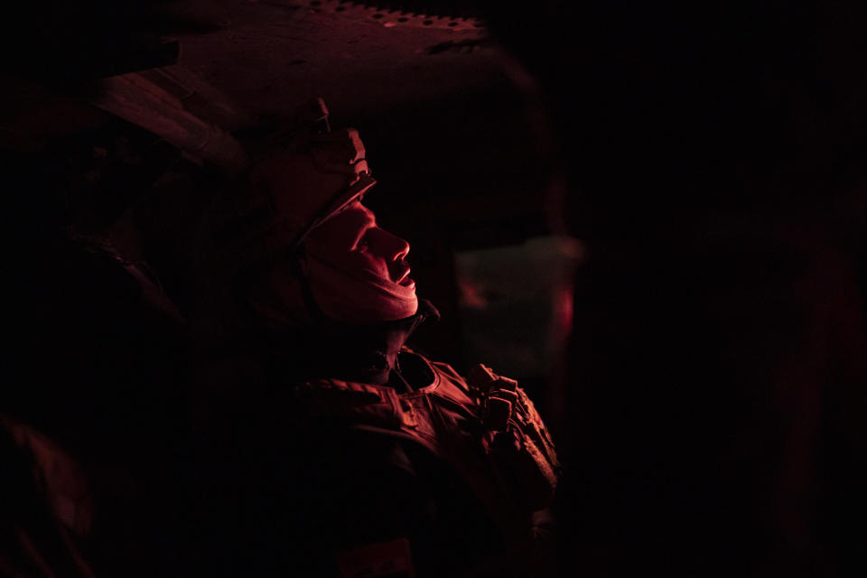 In this April 2, 2019 photo, an Iraqi army 20th division soldier rides in a Humvee during a nighttime raid near Badoush, Iraq. A year and a half after the Islamic State group was declared defeated in Iraq, the northern Iraqi town is a key battleground between security forces trying to stamp out the group's remnants and the militants who have reverted to insurgency. (AP Photo/Felipe Dana)