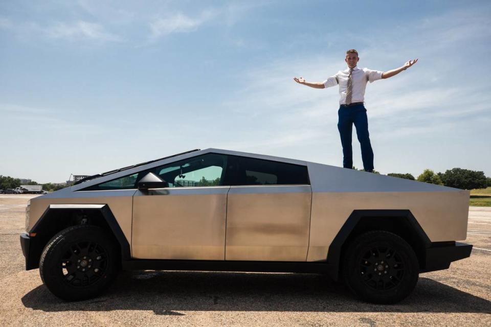 Lawyer and Tesla Cybertruck owner Bryan Willson poses on his car on Friday, August 2, 2024. Willson said he is proud of his Cybertruck and it has always been a dream car for him.