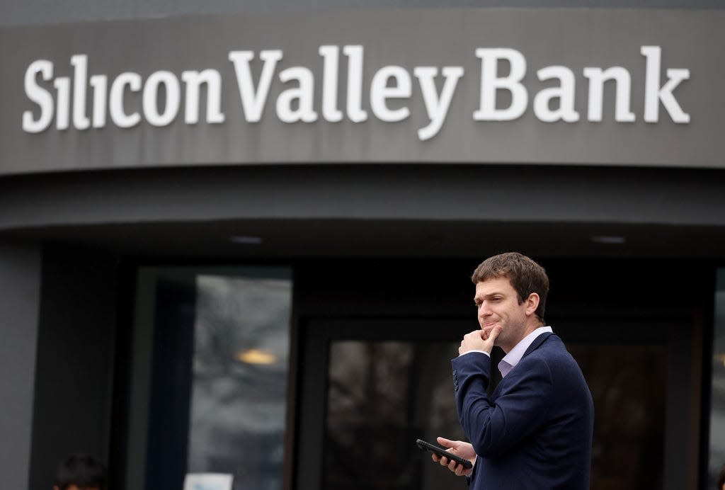 A customer stands outside of the shuttered Silicon Valley Bank headquarters on March 10 in Santa Clara, Calif.