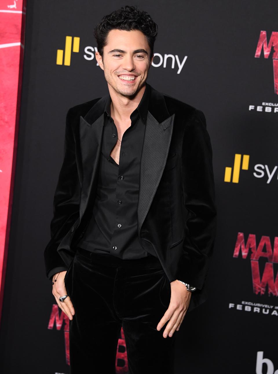 Darren Barnet in black velvet suit smiling on red carpet