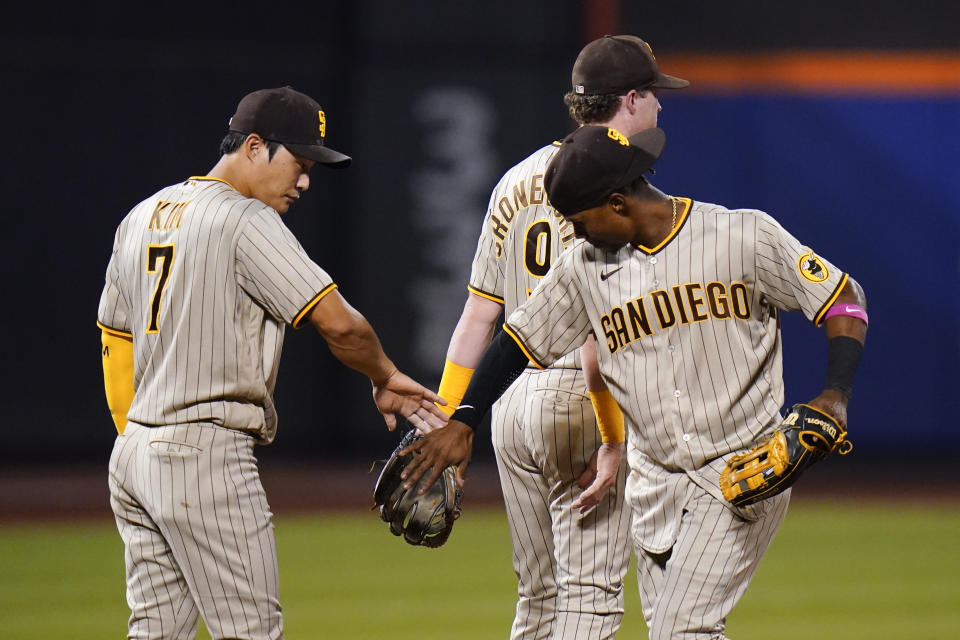 San Diego Padres' Ha-Seong Kim (7), of South Korea, and Jake Cronenworth (9) celebrate after a baseball game against the New York Mets, Saturday, July 23, 2022, in New York. The Padres won 2-1. (AP Photo/Frank Franklin II)