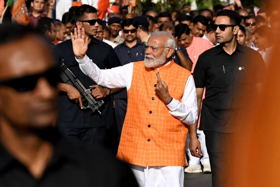 Narendra Modi leaves after casting his vote at a polling booth in Gujarat (AFP via Getty)