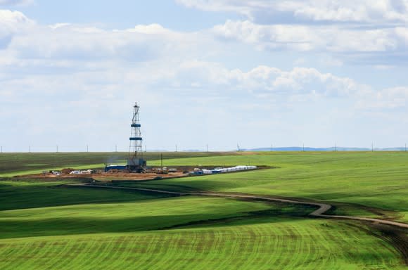 Drilling rig among agricultural fields.