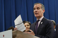 FILE - In this Monday, March 9, 2020, file photo, Los Angeles Mayor Eric Garcetti speaks at a news conference at the Capitol in Sacramento, Calif. In Los Angeles, Garcetti has instituted a shutdown on a city of nearly 4 million people and threatened uncooperative business owners with power shutoffs and arrest amid the new coronavirus pandemic. (AP Photo/Rich Pedroncelli, File)