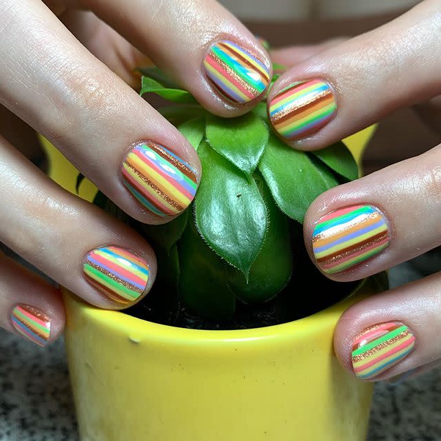 With its tiny stripes in traditionally springy and summery shades like periwinkle, sunny yellow, peachy pink, and neon green, you might think this manicure wouldn't work for fall. Think again! Nail artist Savannah Walker's unexpected <a href="https://www.instagram.com/p/CEGH3CUjfAl/" rel="nofollow noopener" target="_blank" data-ylk="slk:inclusion of colors;elm:context_link;itc:0;sec:content-canvas" class="link ">inclusion of colors</a> like brown and copper make this an amazing transitional manicure — especially with that hint of sparkle on each nail.