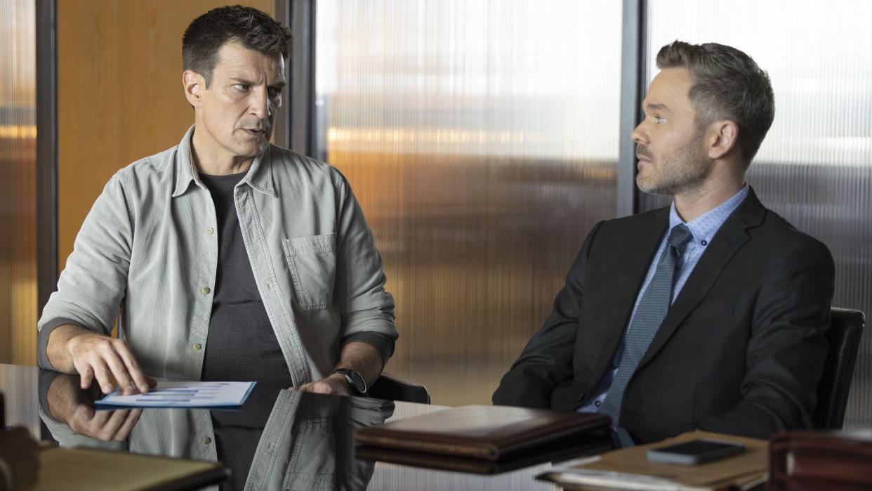  Nathan Fillion and Shawn Ashmore as John and Wesley in an office in The Rookie season 6. 