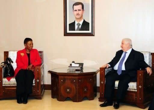 Syrian Foreign Minister Walid al-Muallem (R) meets with UN humanitarian chief Valerie Amos in Damascus. Amos entered the battered Homs neighbourhood of Baba Amr on Wednesday along with a team from the Syrian Red Crescent, as efforts continued apace to bring an end to a year of deadly violence in the country