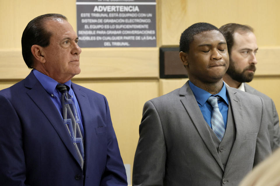 Suspected shooting accomplice Trayvon Newsome, right, inhales deeply as he stands for the jury to enter the courtroom for closing arguments in the XXXTentacion murder trial at the Broward County Courthouse in Fort Lauderdale, Fla., Tuesday, March 7, 2023. Newsome's attorney George Edward Reres, stands at left. Emerging rapper XXXTentacion, born Jahseh Onfroy, 20, was killed during a robbery outside of Riva Motorsports in Pompano Beach in 2018, allegedly by defendants Michael Boatwright, Newsome, and Dedrick Williams. (Amy Beth Bennett/South Florida Sun-Sentinel via AP, Pool)