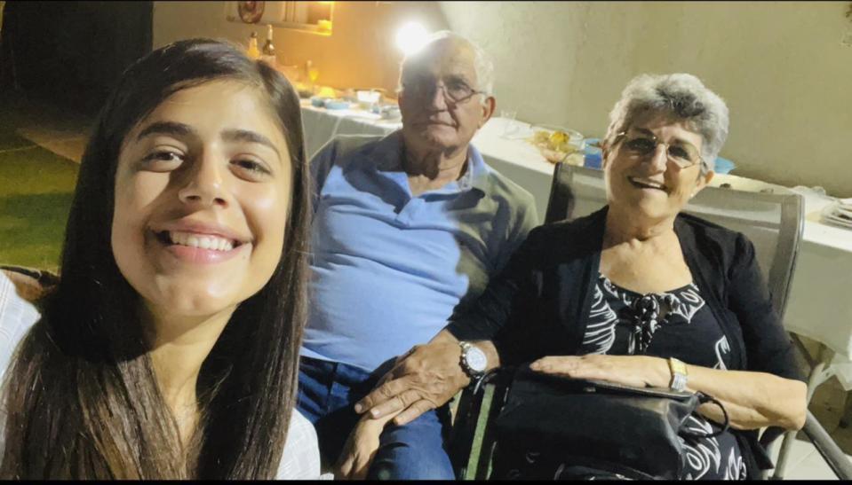 This handout photo provided by Anat Moshe Shoshany/Elinor Shahar Personal Management shows David Moshe, center, his wife Adina Moshe, right, and granddaughter Anat Moshe as they pose for a family photo in Israel, unknown date. (Anat Moshe Shoshany/Elinor Shahar Personal Management via AP)