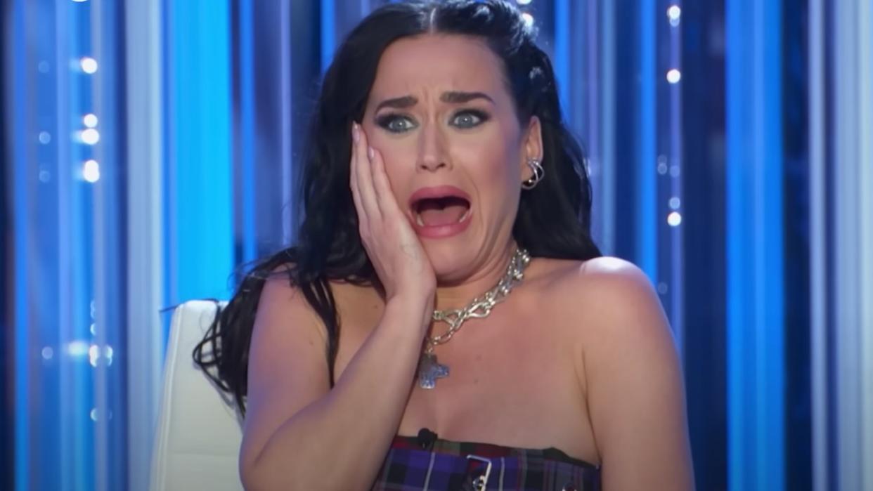  Katy Perry holds her hand to her cheek and screams while judging on American Idol. 