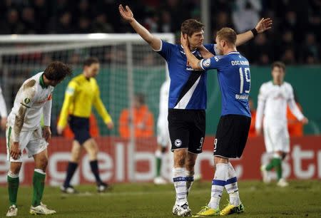 Arminia Bielefeld's Fabian Klos (L) and Felix Burmester celebrate a goal against Werder Bremen during their German Cup (DFB Pokal) soccer match in Bielefeld March 4, 2015. REUTERS/Ina Fassbender