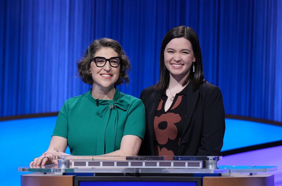 Claire Sattler and host Mayim Bialik on the set of "Jeopardy!" in January 2023. She's appearing in the show's High School Reunion Tournament in February.