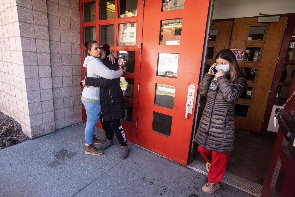 Women whose parents and grandparents are residents of 671 Bronx River Rd. hug outside the Scotti Park Community Center in Yonkers March 8, 2023 after an overnight fire killed one resident and displaced at least 60 families. Residents gathered in the community center where the Red Cross cared for them.