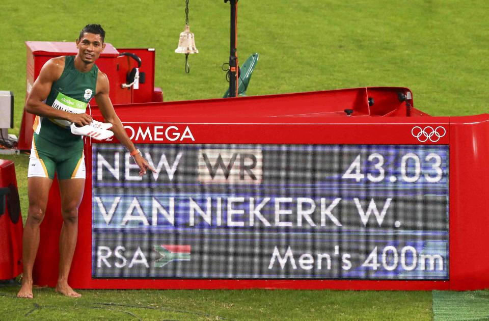 Wayde van Niekerk South Africa poses next to information board showing his world record in the 400M. (REUTERS) 