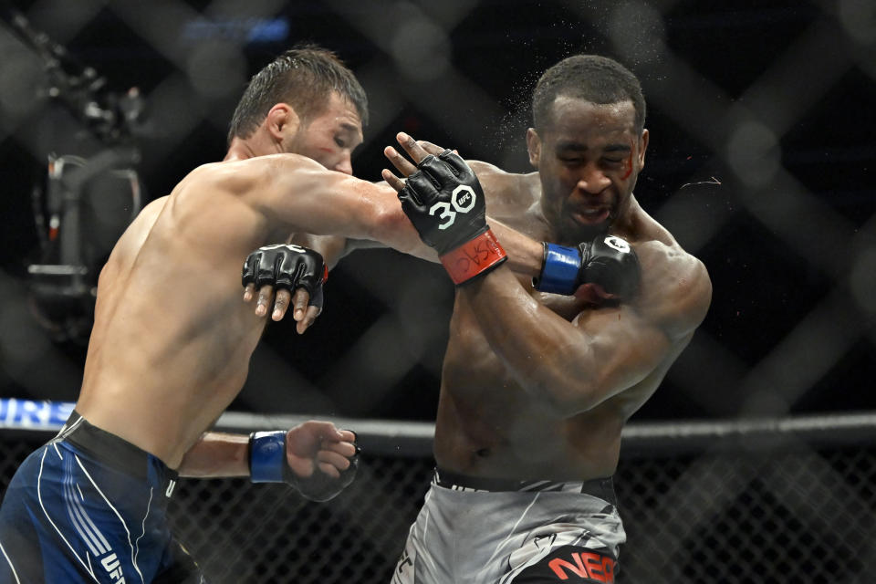 Shavkat Rakhmonov, left, punches Geoff Neal during a UFC 285 mixed martial arts welterweight bout Saturday, March 4, 2023, in Las Vegas. (AP Photo/David Becker)