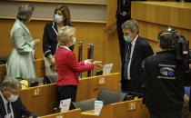 European Parliament President David Sassoli, second right, speaks to European Commission President Ursula von der Leyen, center, prior to the opening of the plenary at the European Parliament in Brussels, Wednesday, May 27, 2020. The European Union is to unveil Wednesday a massive coronavirus recovery plan worth hundreds of billions of euros to help countries rebuild their ailing economies, but the bloc remains deeply divided over what conditions should be attached to the funds. (AP Photo/Olivier Matthys)