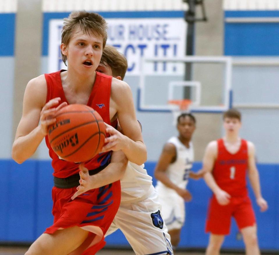 Brewer guard Caleb Lelek (5) reaches around Grapevine’s Conner Maxwell (33) during the second half of a 5A Region 1 bi-district basketball game at Brewer High School in Fort Worth, Texas, Monday, Feb. 22, 2021. Grapevine defeated Brewer 54-46. (Special to the Star-Telegram Bob Booth)