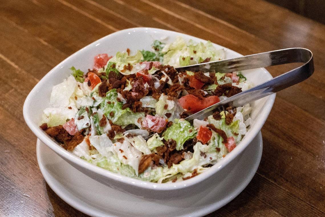 Every steak at Malone’s comes with their bottomless Lexingtonian salad. But when the restaurant first opened, they offered two A bowl of Lexingtonian salad offered another bottomless salads, the “Green Goddess.”
