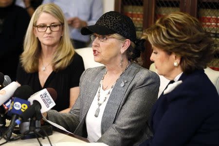 Two of three women who allege they were sexually assaulted by comedian Bill Cosby, Linda Kirkpatrick (L) and an unidentified woman, sit with lawyer Gloria Allred (R) at a news conference in Los Angeles, California, January 7, 2015. REUTERS/Lucy Nicholson