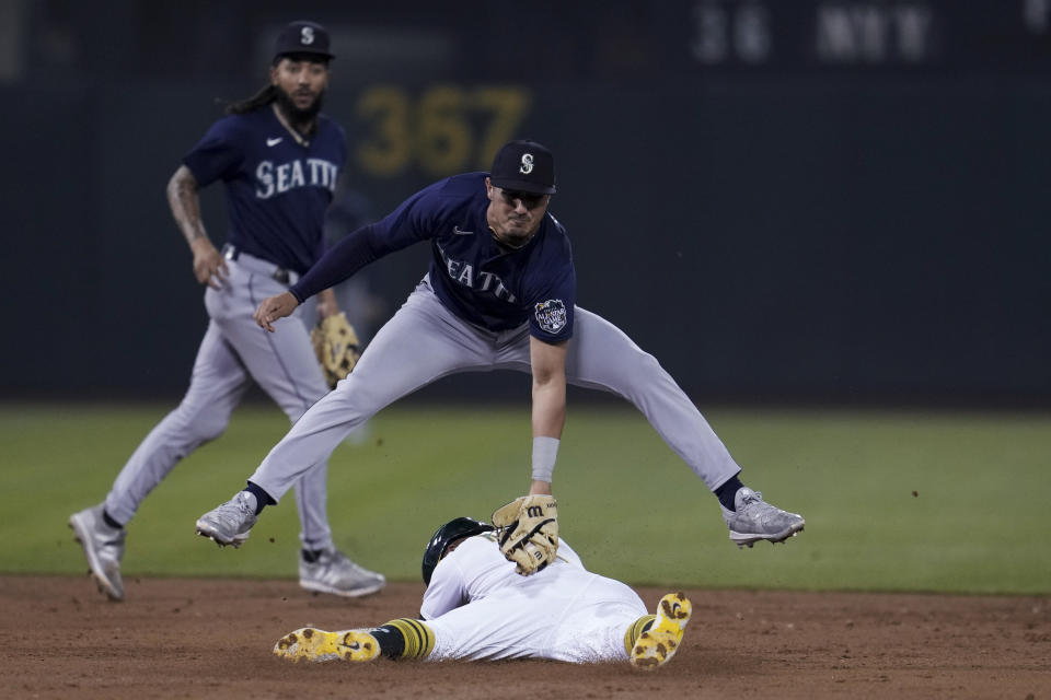 Seattle Mariners second baseman Josh Rojas tags out Oakland Athletics' Tony Kemp, who was attempting to steal second during the third inning of a baseball game Tuesday, Sept. 19, 2023, in Oakland, Calif. (AP Photo/Godofredo A. Vásquez)