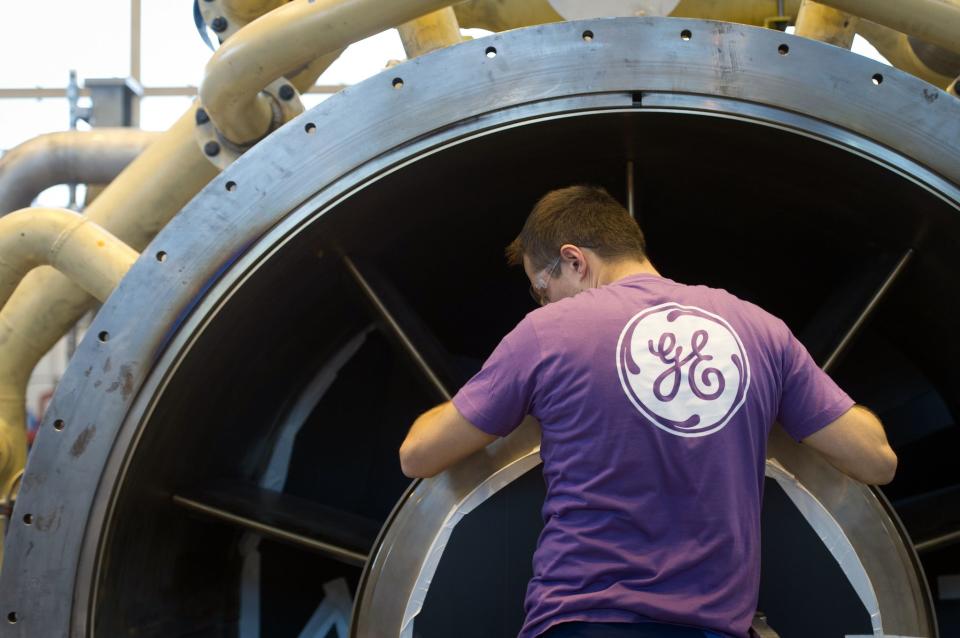 An employee of US multinational General Electric (GE) works on a gas turbine at the GE plant in Belfort, eastern France, on October 27, 2015. (Photo: SEBASTIEN BOZON/AFP/Getty Images)