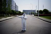 Worker in a protective suit is seen at a Dongfeng Honda factory in Wuhan