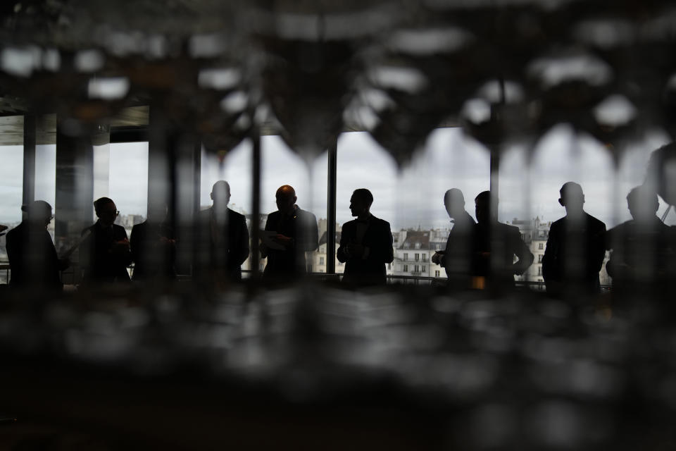 Waiters during a briefing at La Tour d'Argent restaurant in Paris, Wednesday, Dec. 13, 2023. The Tour d'Argent, which claims to be the oldest restaurant in the French capital, has a front-row view of the renaissance of Notre Dame Cathedral as artisans prepare the fire-ravaged monument for reopening next year. The high-end restaurant, which helped inspire the movie "Ratatouille,'' recently reopened after its own renovation that preserved traditions while adapting to the 21st century. It will also overlook the opening ceremony of the Paris Olympics on July 26, 2024. (AP Photo/Christophe Ena)